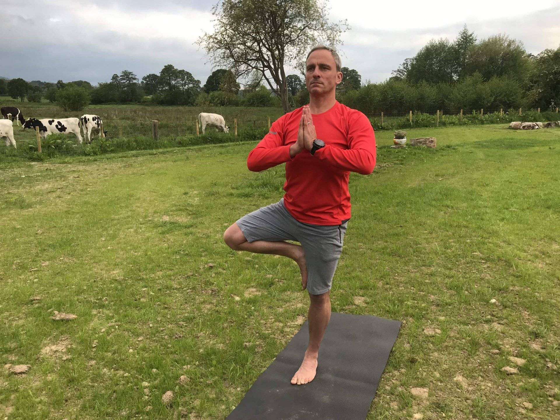 man doing one legged balance yoga pose
