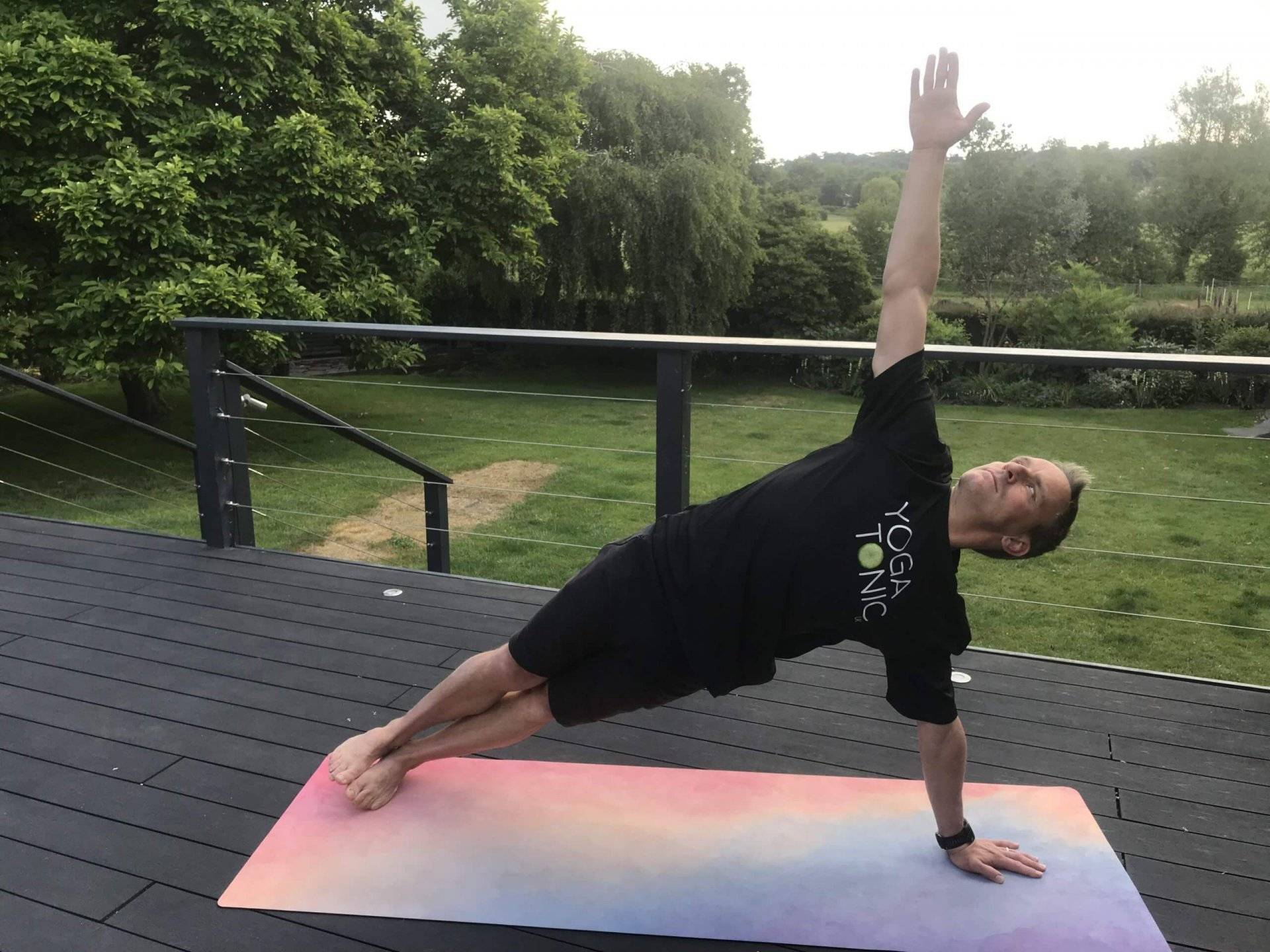 man doing vasisthasana / side plank yoga pose