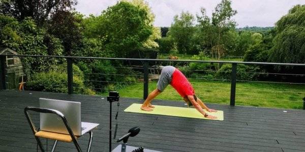 man practicing yoga in online yoga video